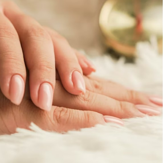 Abstract soft swirl nail art in peach and cream tones